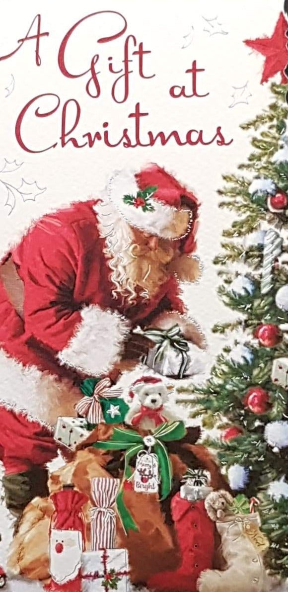 General Christmas Card - A Gift at Christmas & Santa Putting Gifts Under Tree